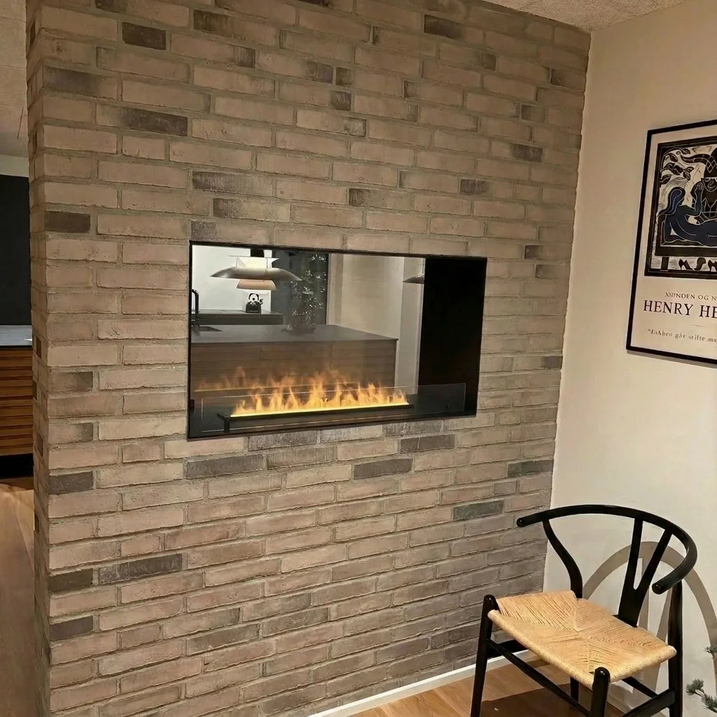 Foco Myst Two 800 built-in water vapour fireplace with a low water vapour flame in a grey brick partition wall