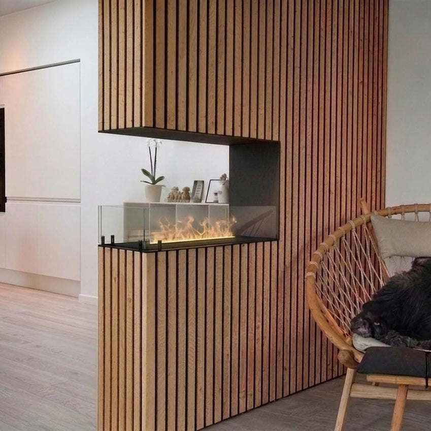 Foco Myst Room Divider 800 water vapour fireplace in a Scandinavian living room with a wood-slat surround, with a low lit water vapour flame